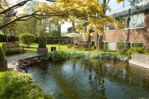 The exterior of BizSpace Dorking office property with lake in foreground