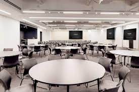 A room with large meeting tables at Convene, 117 W 46th Street, Midtown West, New York, NY 10036