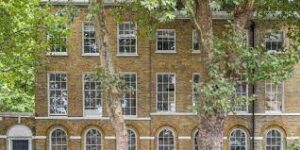 The exterior of EatWorkArt, Cornerstone Studios, Camberwell, London, SE5 7JZ with foliage in the foreground