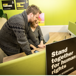 Two people working at a desk at Ethical Property Green Fish Resource Centre, 46 - 50 Oldham Street, Northern Quarter, Manchester M4 1LE