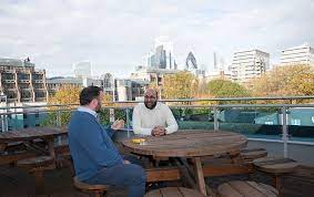 Two gentleman chatting on the roof terrace at LentaSpace St Katharine Docks - 46-48 East Smithfield, E1W 1AW