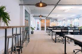 A shot of coworking desks with a mix of desks and high stools at Techspace Shoreditch South - 32-38 Scrutton Street, London EC2A 4RQ