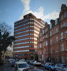 External shot of 3 Space's International House, 6 Canterbury Crescent, Brixton, London SW9 7QD looking up from the ground with a blue sky behind