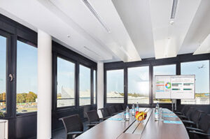 A meeting room for hire at Agendis Frankfurt Airport with a view of an aeroplane through the window