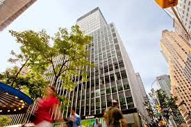 Looking up at Breather - 733 Third Ave, New York 10017 with pedestrians in the foreground