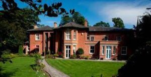 External shot of the DBS - The Old Vicarage, Market Street, Castle Donington, Derbyshire DE74 2JB office property showing landscaped grounds in the foreground 