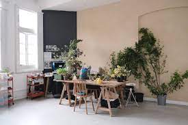 A workspace with a display board and flowers at Meantime Studios in Greenwich