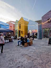 Open air seating in the yard area at Meanwhile Space Coworking Desks at Blue House Yard in Wood Green