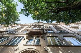 Looking up at the entrance of the Office Lodges - Kaiserstraße 53, 60329 Frankfurt am Main, Germany office property through trees on the street