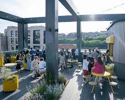 People co-working on the roof terrace of Plus X Innovation, Lewes Road, Brighton and Hove, Brighton BN2 4GL