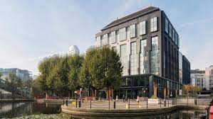 Exterior shot of Republic London Export Building - 1 Clove Crescent, East India Docks, London E14 2BA with trees in the foreground