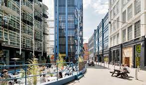 External shot of The Custard Factory, Gibb Street Digbeth Birmingham B9 4AA showing public realm and outdoor seating areas