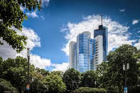 Shot of Work Republic Alte Oper – Neue Mainzer Str. 75, 60311, Frankfurt am Main office space tower taken from Taunusanlage park with trees in foreground