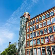 External shot looking up at WorkSmart Services in Broadstone Mill in Stockport office space property on a sunny day