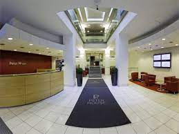 Reception desk and waiting area opposite in Regus - Peter House, Oxford Street, Manchester M1 5AN