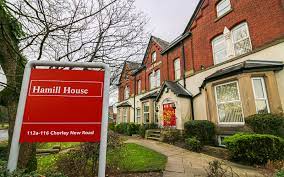 External shot of Wrkspace - Hamill House, 112-116 Chorley New Road, Bolton BL1 4DH office building with signage in the foreground