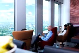 Clients working in a coworking lounge with great views at Ecos Workspace - Alfred-Herrhausen-Allee 3-5 65760 Eschborn