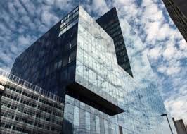 Looking up at Cubo - No.1 Spinningfields, Manchester M3 3JE showing reflections of the clouds and sky in the cladding