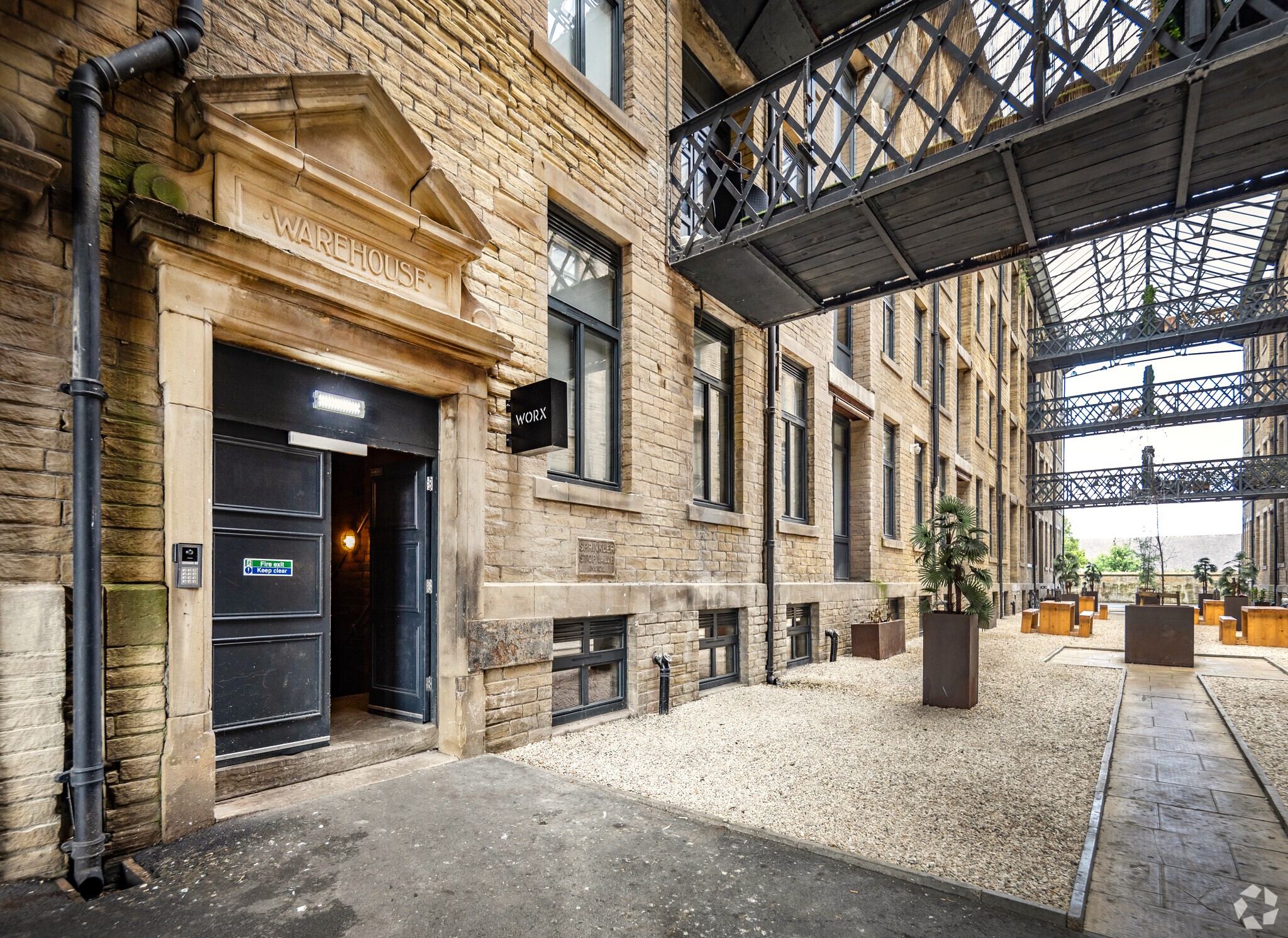 Outdoor seating and the entrance at Worx Offices - Conditioning House, Cape Street, Bradford BD1 4QG