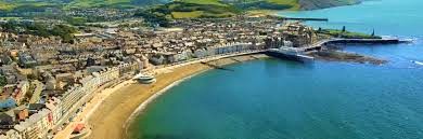 Aerial view of various properties and the shoreline of Aberystwyth
