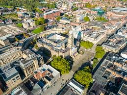 An aerial view of Bolton town centre showing various buildings including office properties and the town hall