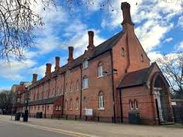 The view from the street of Eco Innovation Centre - Peterscourt, City Road, Peterborough PE1 1SA on a sunny day with a tree branch in the foreground