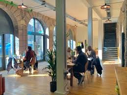 Coworking space with large windows and exposed brickwork at Flour Mill - 34 Commercial Street, Dundee DD1 3EJ