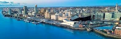 Liverpool city centre from the River Mersey showing modern properties and iconic structures such as the Liver Buildings