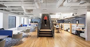 The central stairway at Spaces - Met Tower, 142 W 57th Street, New York City, New York 10019 with coworking desks in the background