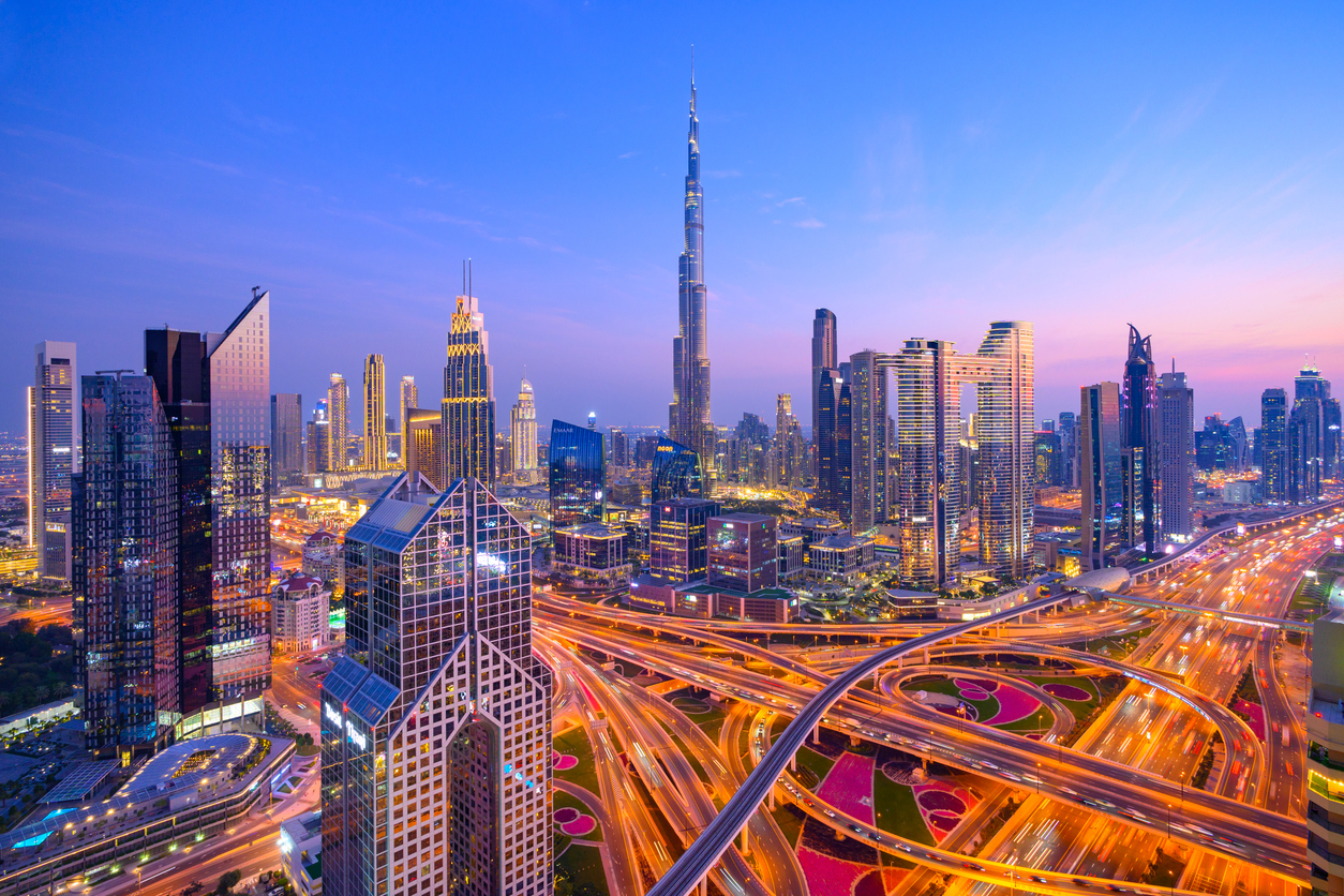 Aerial view of Downtown Dubai at night with Burj Khalifa and commercial and office buildings in view