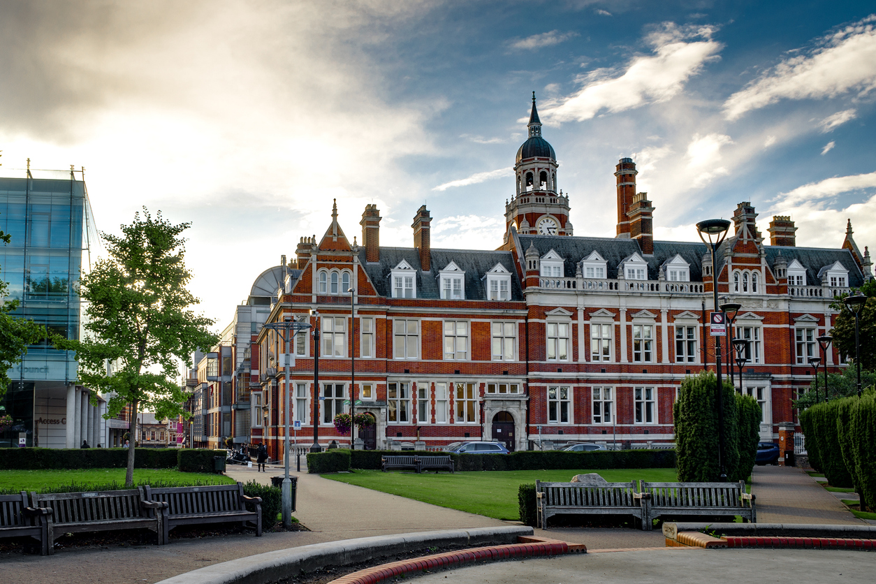 Croydon's clock tower and library and other commercial properties with a lawn in the foreground
