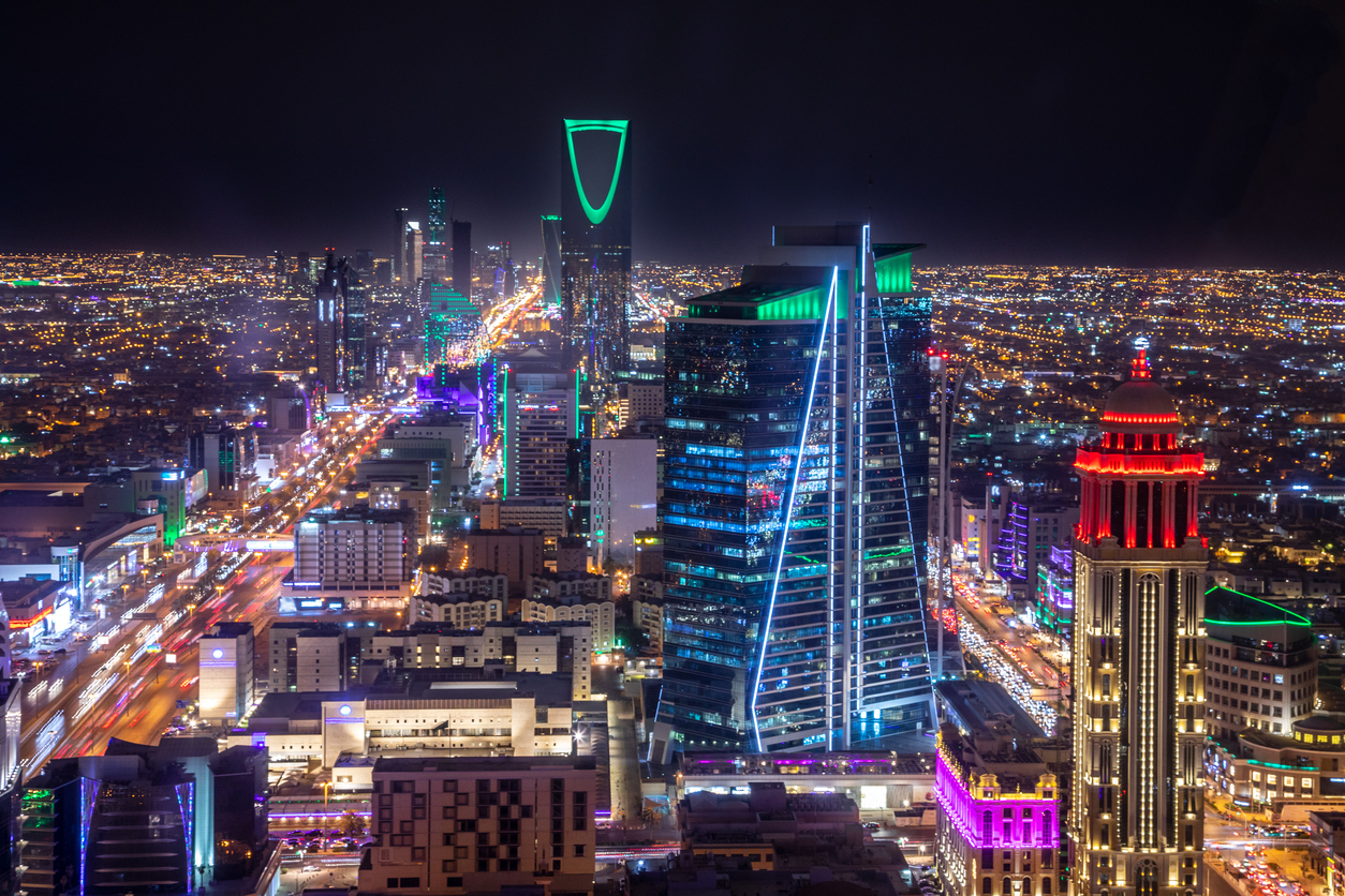 A panorama of Riyadh at night showing office buildings and other commercial properties